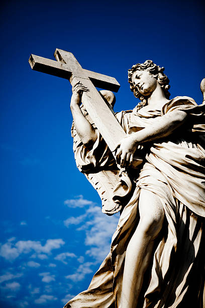 Angel with cross at Ponte Sant'Angelo bridge in Rome.
