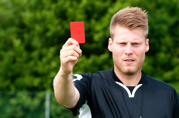 istock Referee looks angry and shows a red card 182915127