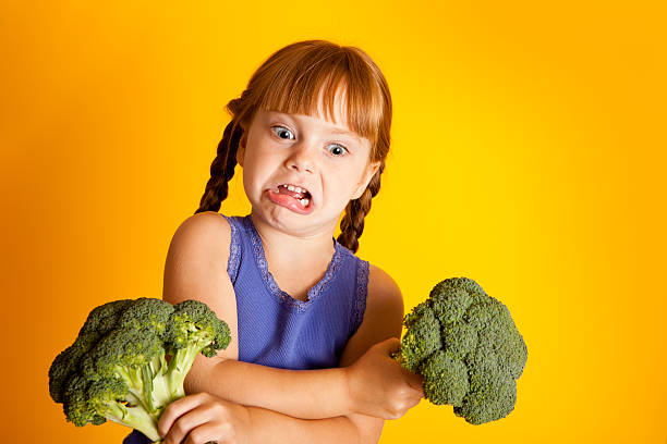 istock Little Red-Haired Girl Disgusted with Broccoli 182915436