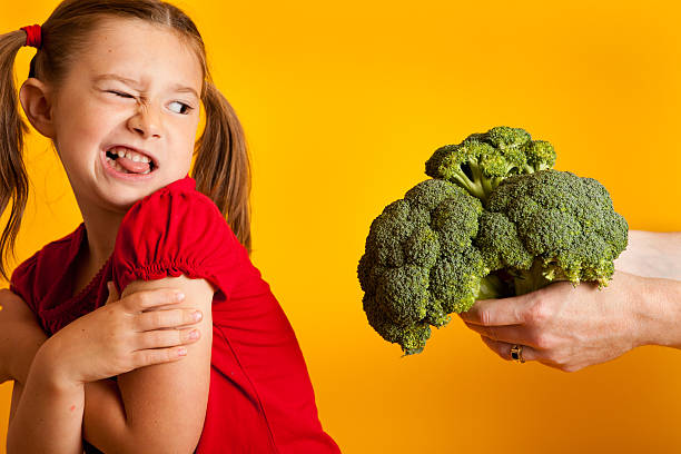 istock Young Girl Disgusted with Broccoli 182915443