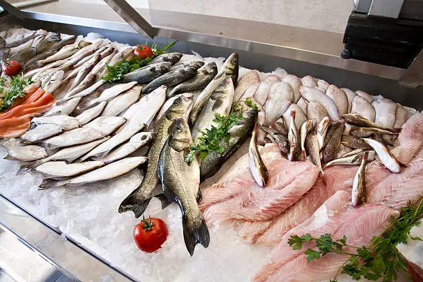 Photo of Lots of freshly caught fish displayed at the wet market