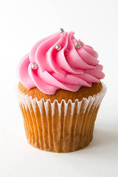 A picture of a cupcake with strawberry frosting stock photo