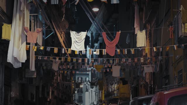 Hanging clothes in a vibrant Naples street at night, Italy