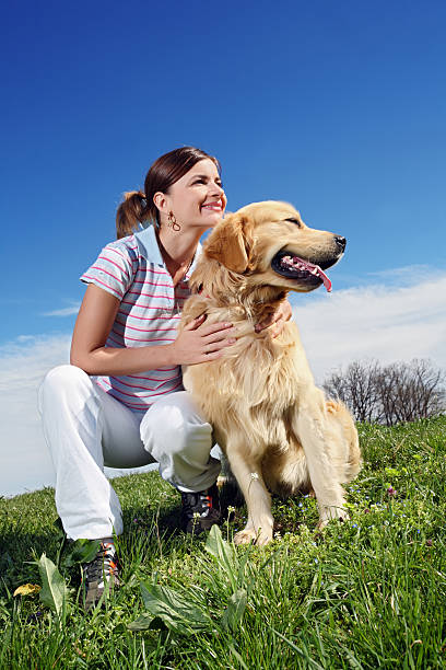 istock Young woman with  golden retriever.. 182916438