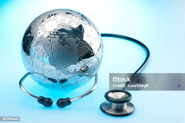 Stethoscope And Chrome Earth Globe Puzzle Stock Photo - Download Image Now - Globe - Navigational Equipment, Jigsaw Puzzle, Absence