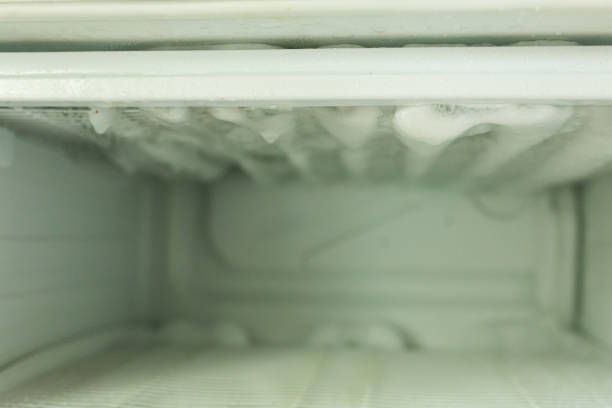 istock Ice in the refrigerator freezer. Defrosting 1829165249