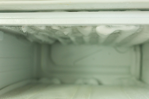 Ice in the refrigerator freezer. Defrosting