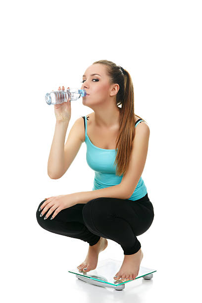 istock young girl on glass scale 182917017
