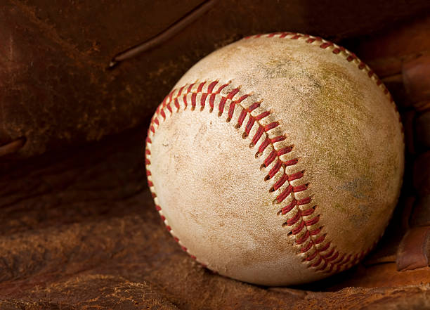 istock Used Baseball Inside of a Glove 182917294