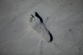 Footprint In Black Sand At The Beach