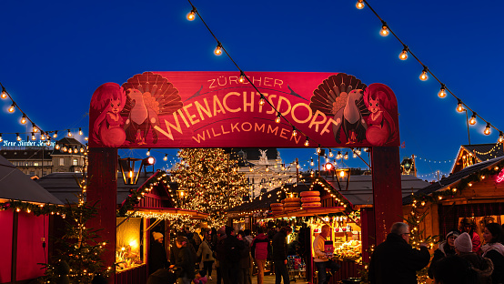 Zurich, Switzerland - November 23, 2023: Christmas market in front of the opera house at the Sechselautenplatz square-Bellevue in Zurich in blue hour