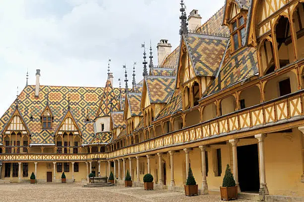 "Polychromic glazed-tile roof of the Hospices de Beaune - a charitable institution built in the XVth century. These four color tiles became characteristic for the Burgundy architecture. Burgundy, France."