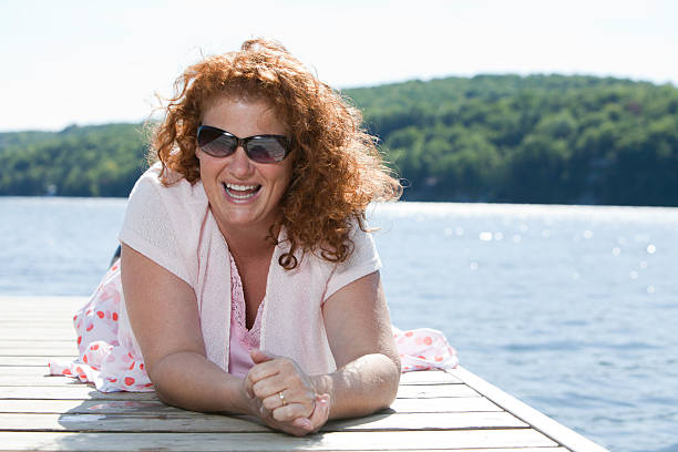 женщина luaghing на dock - image date one person happiness outdoors стоковые фото и изображения
