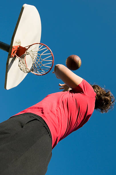 istock Young woman shooting basketball 182919187