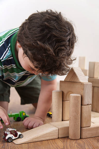 istock Little Boy Playing With Blocks and Cars 182919477