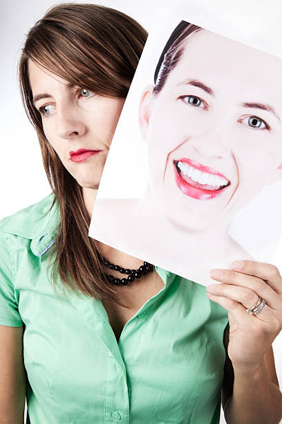 istock Depressed Woman Hiding Behind A Smiling Face 182919752