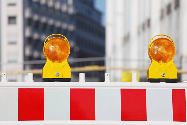istock two yellow traffic warning lamps on barricade 182920141