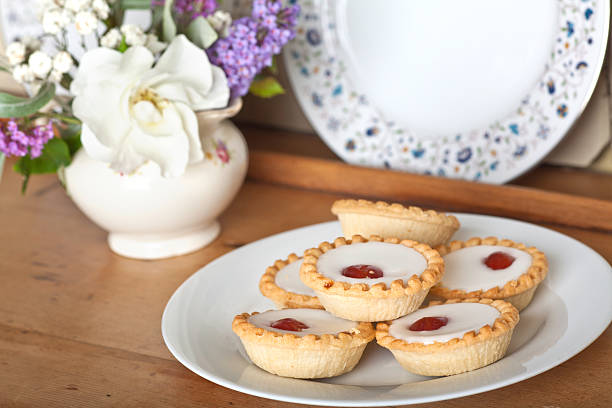 Bakewell Tarts Plate of cherry bakewells on dresser bakewell stock pictures, royalty-free photos & images