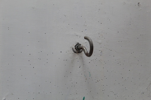 Close-up of the hook nail on the white wall. suitable for copy space and background themes