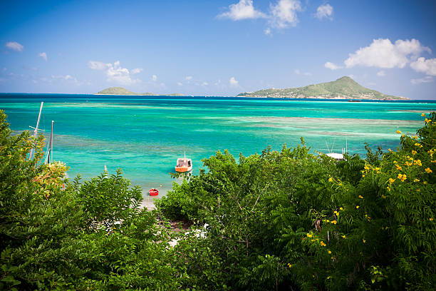 Boats in the Caribbean Sea,  Winward village, Carriacou island, Grenada. The two distant islands in haze are Petit St Vincent (left) and Petite Martinique (right).