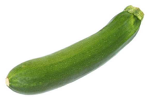 Whole green zucchini on a white background Zucchini  courgette stock pictures, royalty-free photos & images