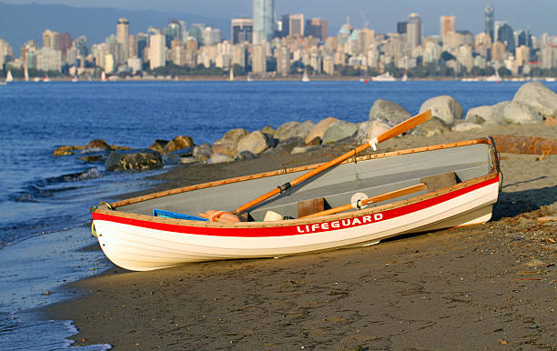 Lifeguarding in Vancouver A lifeguard boat waits the call to launch on Vancouver beach. beach english bay vancouver skyline stock pictures, royalty-free photos & images