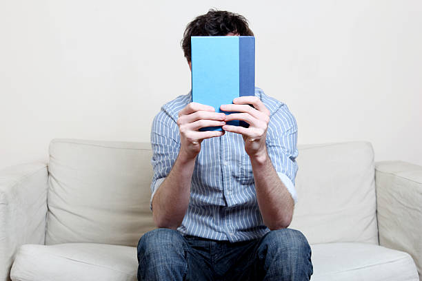 istock Male in blue shirt reading a book 182921542