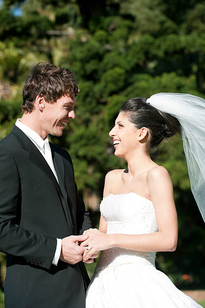 istock A bride and groom holding hands outside 182921865