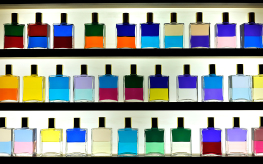 Multi coloured Aromatherapy oils in glass bottles and stacked on shelving in a beauty salon, These oils are used in massage and relaxation therapies for Stress, Insomnia, Depression etcetera. 