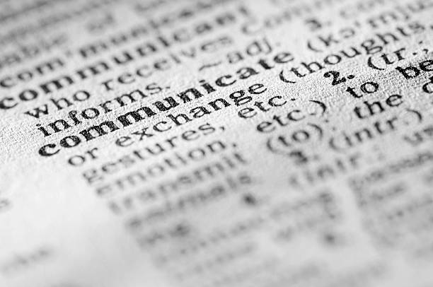 istock Dictionary definition of communicate in black type 182922337