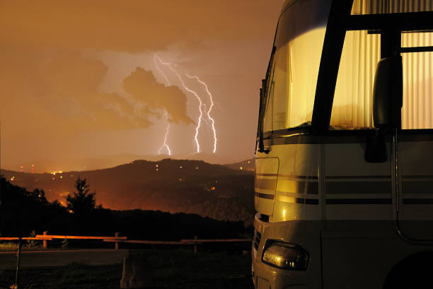 Lightning storm in front of motorhome stock photo
