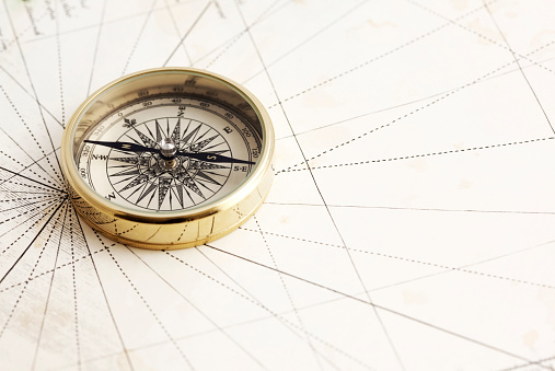 Elegant gold compass on antique map