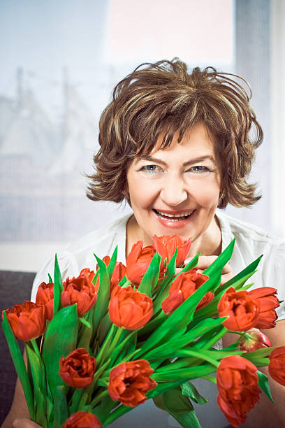 istock Mature woman with flowers 182923234