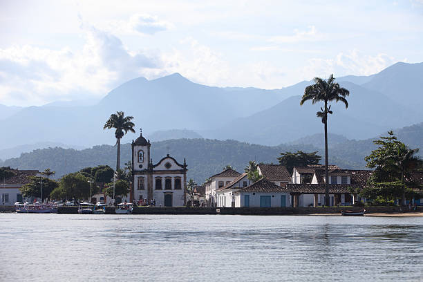 Courtyard, Paraty, Brazil. Paraty, located on the Costa Verde (Green Coast) is a well preserved Portuguese colonial and Brazilian Imperial municipality - the name originating from the local Guaianá Indians' indigenous Tupi language, for an abundant local fish native to the region. Paraty has become a tourist destination, known for its historic town centre and surrounding coast and mountains.