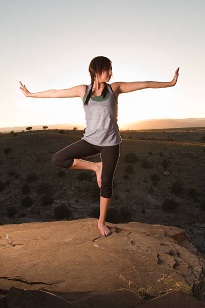 istock Young Woman Doing Yoga at Sunset 182923507