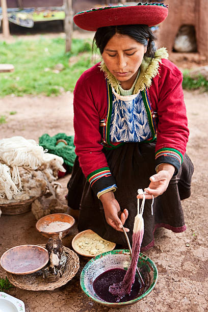 istock Peruvian woman dyeing wool, The Sacred Valley, Chinchero 182923922