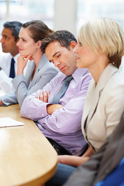 istock Tired male worker sleeping in a meeting 182924182