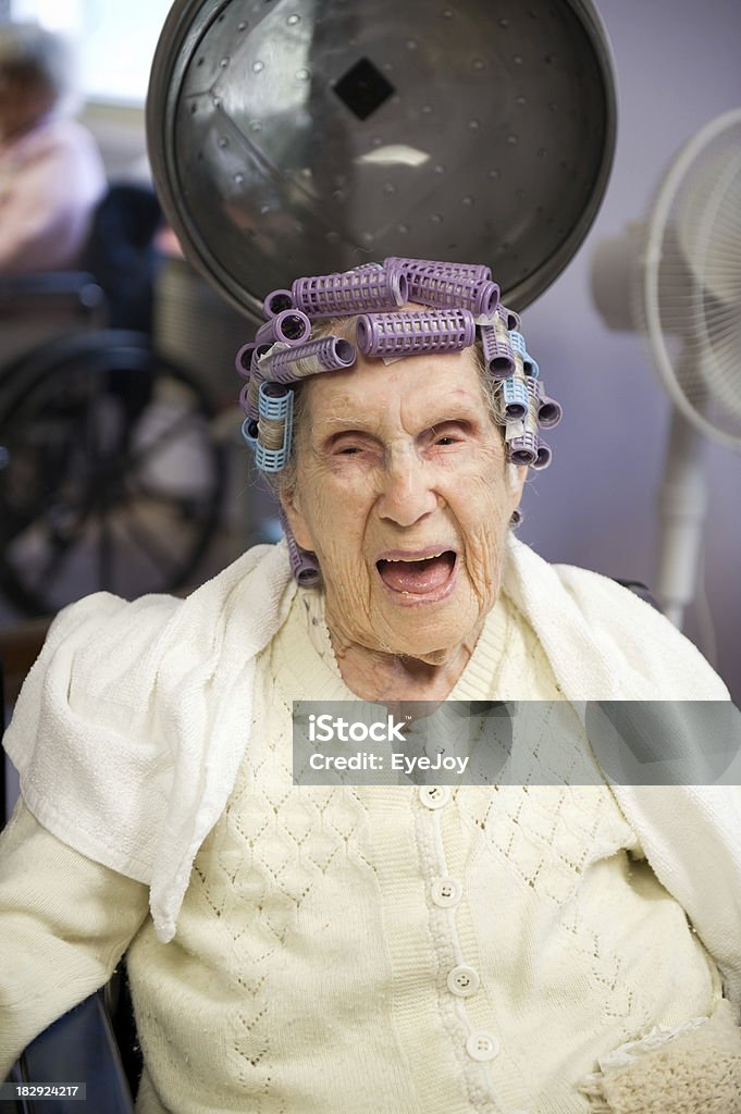 Laughing Centenarian in Curlers Candid of a 103-year-old centenarian in curlers looking at camera. Adult Stock Photo
