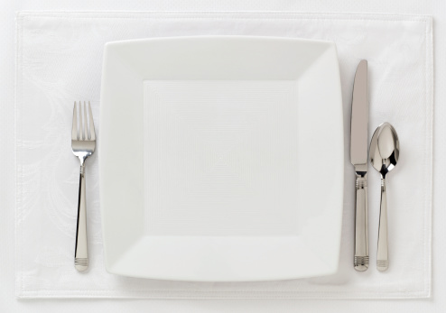 Contemporary table place setting; white on white; area for copy left open