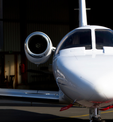 Close-up of a corporate jet-plane parked inside a hangar.More of this series: