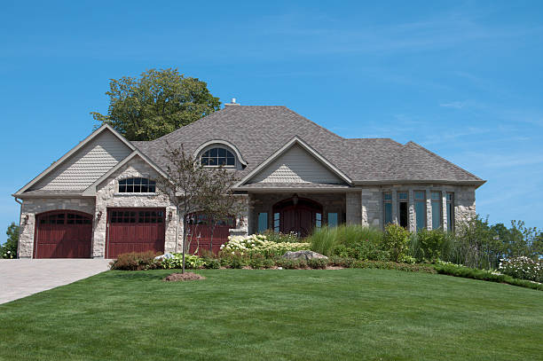 istock An executive home with front lawn on a sunny day 182925632