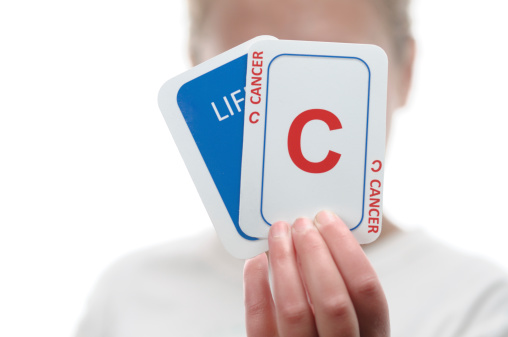 Child holding life and cancer card in concept series cards we are dealt in lifeCards made by contributor