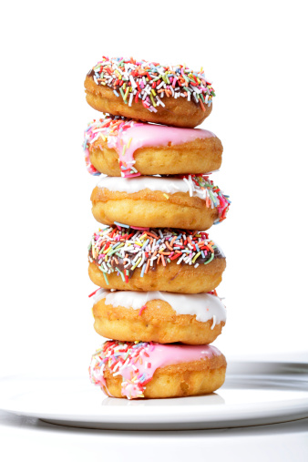 Iced donuts stacked on a plate