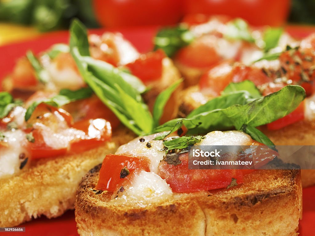 Bruschetta with tomatoes, cheese, and basil "Italian bruschetta with tomato, mozzarella and basil" Appetizer Stock Photo