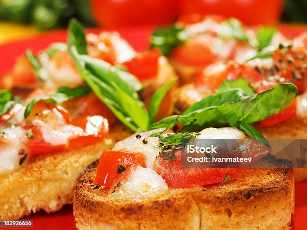 Bruschetta With Tomatoes Cheese And Basil Stock Photo - Download Image Now - Appetizer, Basil, Bread