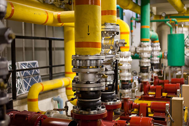 Multicolored pipes in a boiler room a shot of some pumps and plumbing in a boiler room. Shallow D.O.F. air valve photos stock pictures, royalty-free photos & images