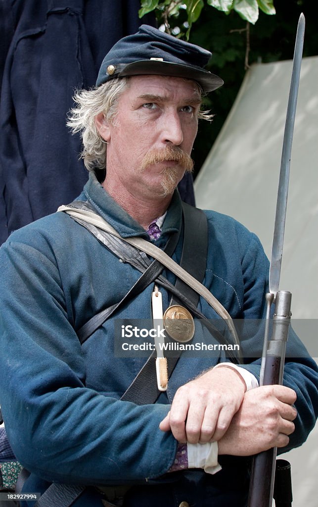 American Civil War Union Soldier Holding Company Toothbrush An American Civil War reenactor portraying a Union infantryman.  Rumor has it that this soldier was carrying a toothbrush used by all of the men in his company.  Don't know if there is any truth to this!!  Focus on the soldiers face. American Civil War Stock Photo