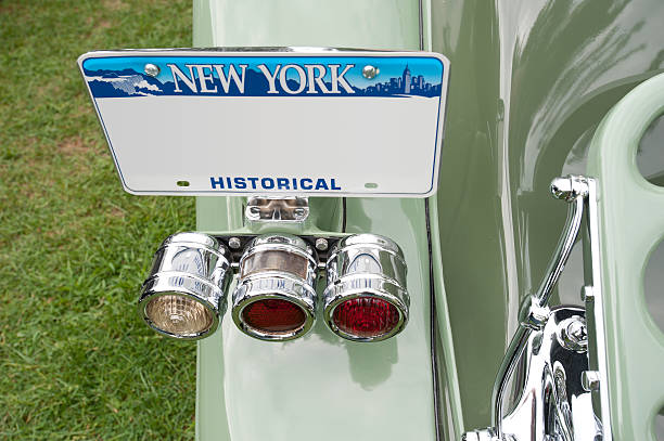 New York Historical License plate on antique car A blank historical New York license plate mounted on a perfectly restored green antique car. new york state license plate stock pictures, royalty-free photos & images