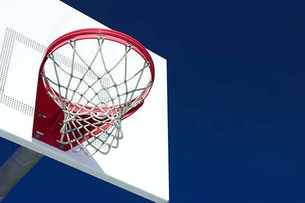 istock Basketball hoop against blue sky 182928205