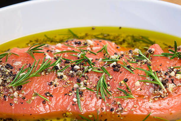 salmón marinado en pescados y mariscos, platos de la cocina saludable, rosemary & aceite de oliva marinade - pink salmon fotografías e imágenes de stock